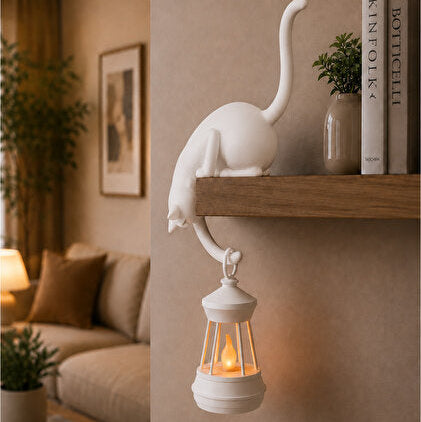 Cream Nookglow cat shelf lantern glowing on a bookshelf